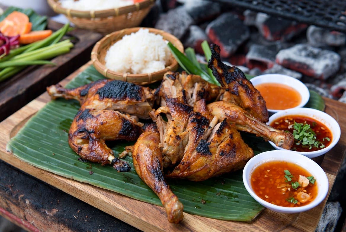 Charcoal-grilled Isan chicken (kai yang) on skewers